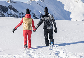 Paar von hinten gesehen im Schnee in Hintertux