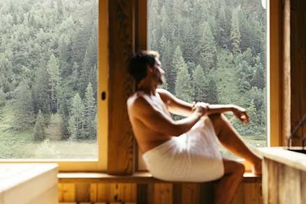 Mann sitzt auf Bank in der Panorama Sauna im Neuhintertux